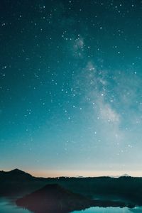 Scenic view of silhouette mountain against sky at night