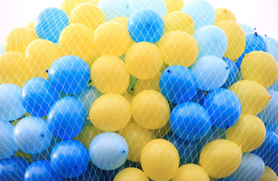 Close-up of multi colored balloons in net