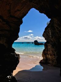 Scenic view of sea seen through cave