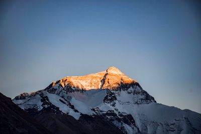 Scenic view of snowcapped mountains against clear blue sky