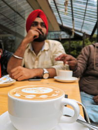 Mid section of a coffee cup on table