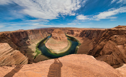 Scenic view of rock formations against cloudy sky