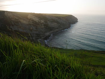 Scenic view of sea and landscape against sky