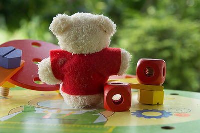 Toys and teddy bear on table
