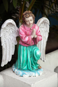 Close-up of angel statue on table