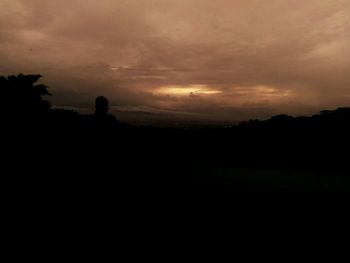 Silhouette landscape against sky during sunset