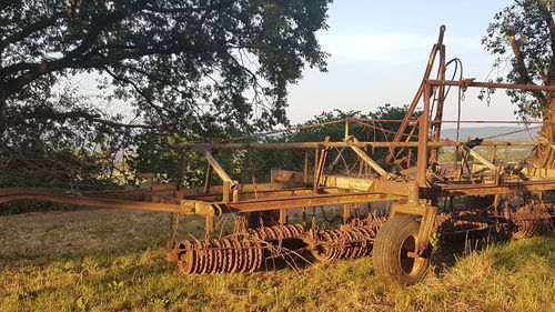 Abandoned truck on field against sky