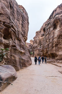 People walking on rock formation