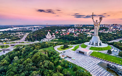 Aerial view of city against sky during sunset