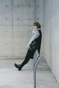 Full length of woman standing by railing
