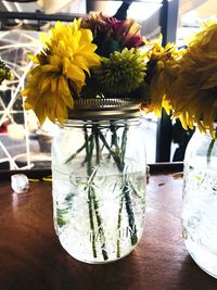 Close-up of yellow flowers in vase on table