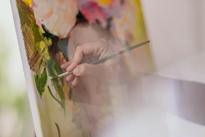 Cropped hand of woman working on table