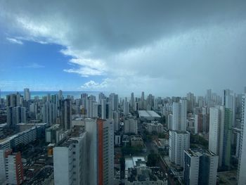 High angle view of modern buildings in city against sky