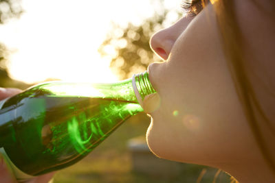 Midsection of woman drinking water from bottle