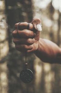 Close-up of hand holding pendant