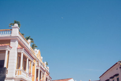 Low angle view of buildings against blue sky