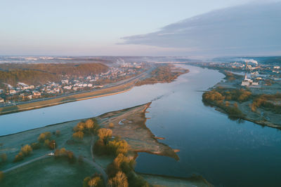 Aerial view of river and city against sky