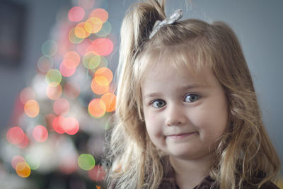 Close-up portrait of cute smiling girl at home