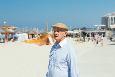 Portrait of man on beach against sky