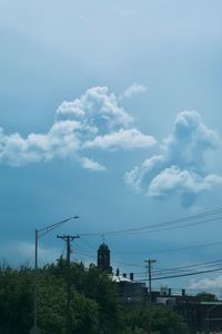 Low angle view of electricity pylon against sky