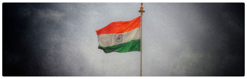 Low angle view of flag hanging against wall