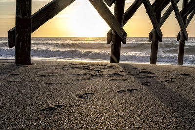 Scenic view of beach against sky during sunset