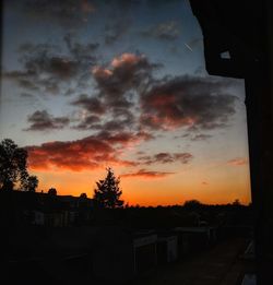 Silhouette buildings against sky during sunset