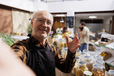 Portrait of senior man drinking glass