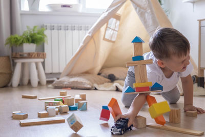 Portrait of boy playing with toys on table