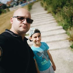 Portrait of young man wearing sunglasses standing outdoors