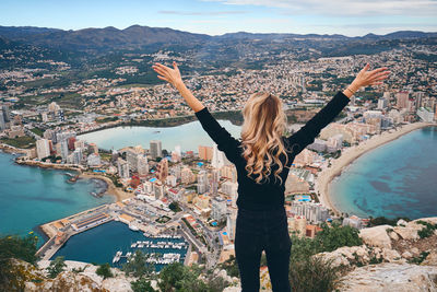 Rear view of woman looking at city buildings