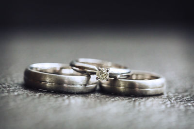 Close-up of wedding rings on table