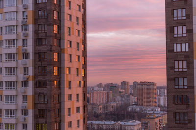 Buildings in city at sunset