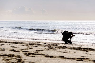 Full length of man on beach against sky