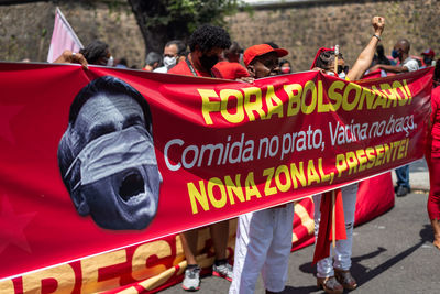 Protester carries banner during demonstration against president jair bolsonaro 