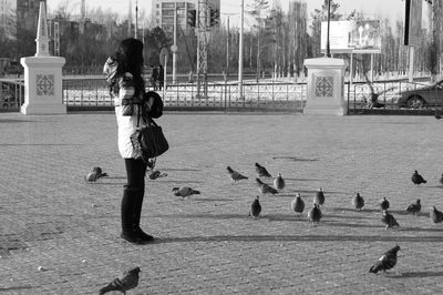 Side view of a woman standing outdoors