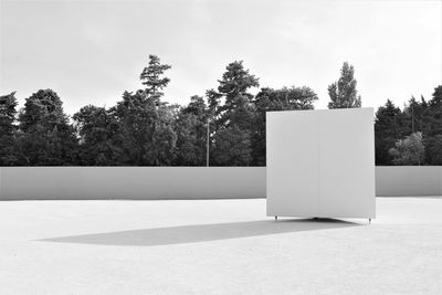 White cube on a place, near trees 