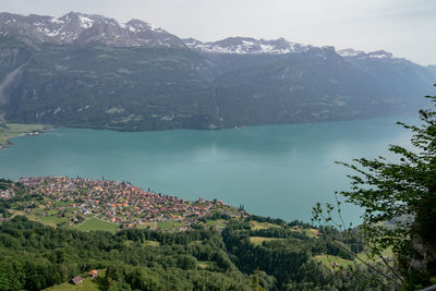 High angle view of townscape by mountains against sky