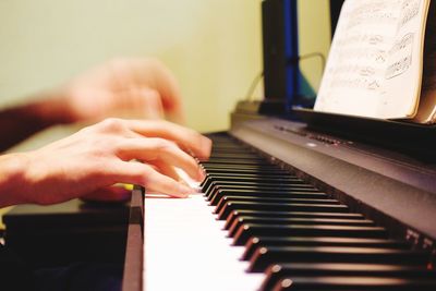 Midsection of man playing piano