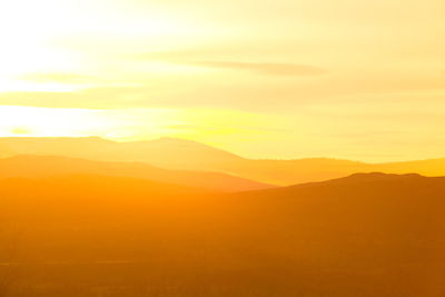 Scenic view of silhouette mountains against sky during sunset