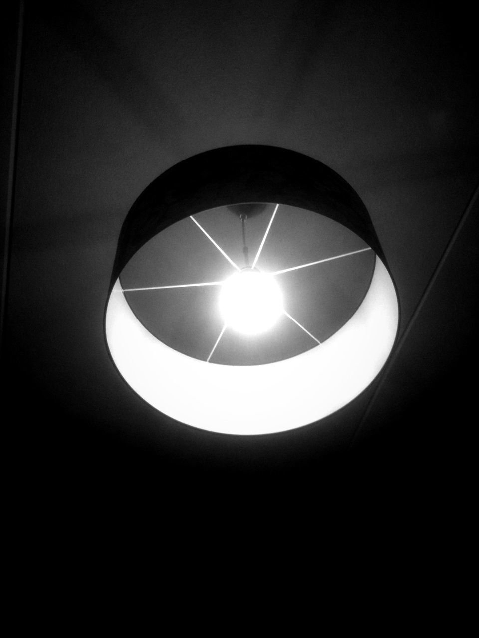 low angle view, lighting equipment, illuminated, indoors, circle, electricity, electric light, built structure, geometric shape, ceiling, electric lamp, directly below, light bulb, dark, glowing, architecture, no people, night, light - natural phenomenon, reflection