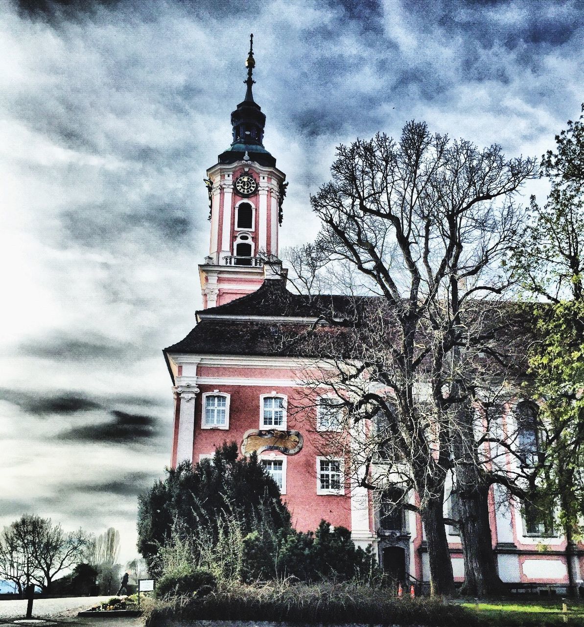 building exterior, tree, architecture, built structure, religion, sky, place of worship, church, low angle view, spirituality, cloud - sky, cloudy, cloud, tower, cross, branch, facade, bare tree