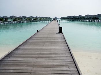 Pier over sea against clear sky