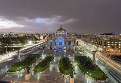 High angle view of illuminated palacio de bellas artes against cloudy sky during sunset