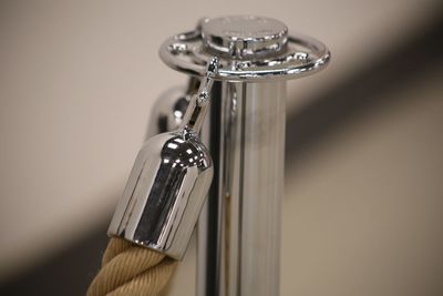 Close-up of electric lamp on table against wall