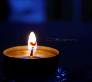 Close-up of lit tea light candle