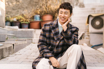 Young man sitting outdoors