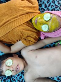 High angle view of woman lying on bed