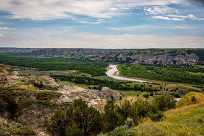 Scenic view of landscape against cloudy sky