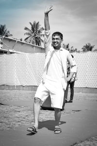 Full length portrait of young man standing outdoors